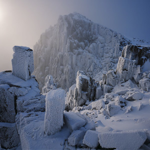 The calendar cover image for 2014. It shows dolerite columns and boulders looming out of the mist at Mt Field National Park in Tasmania. The image is by Grant Dixon.